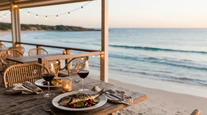 Mesa con pescado a la parrilla y copas de vino al atardecer, frente al mar, en uno de los restaurantes imperdibles en Punta del Este